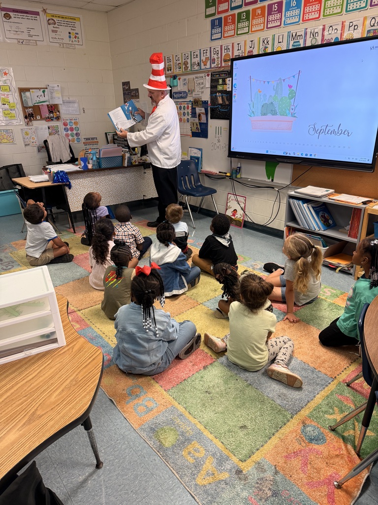 students, adult dressed as cat in the hat, book, classroom