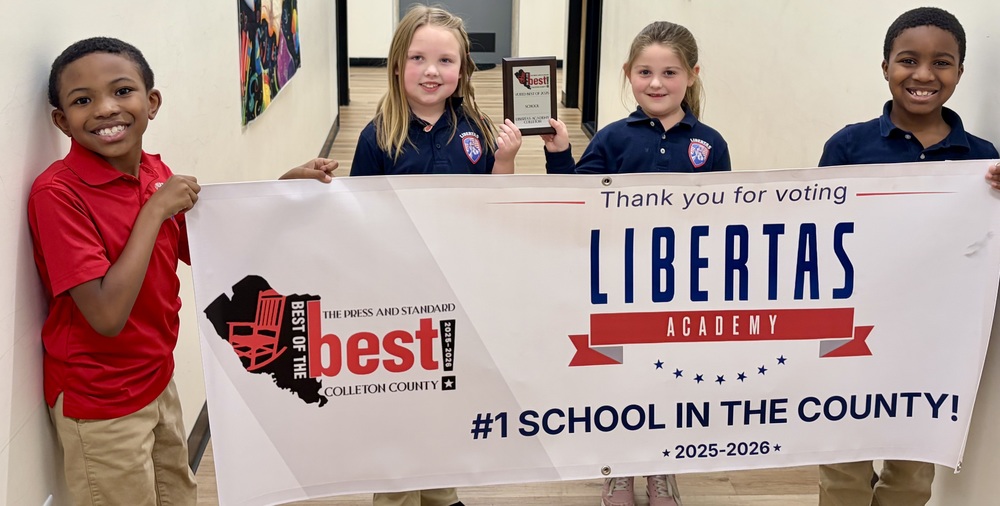 Student holding award