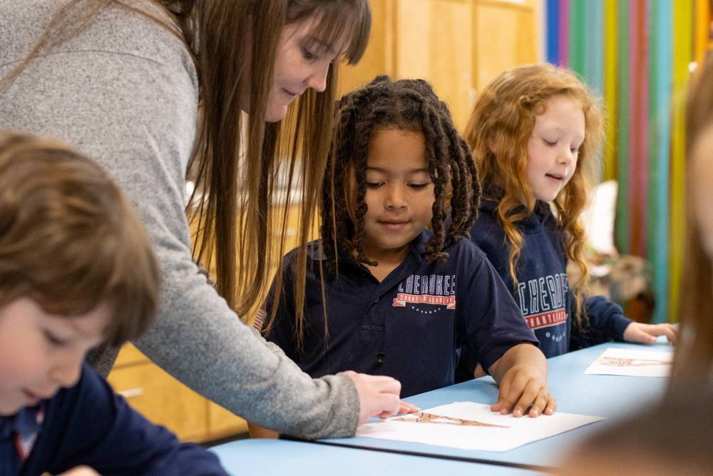 CCA teacher assisting a student