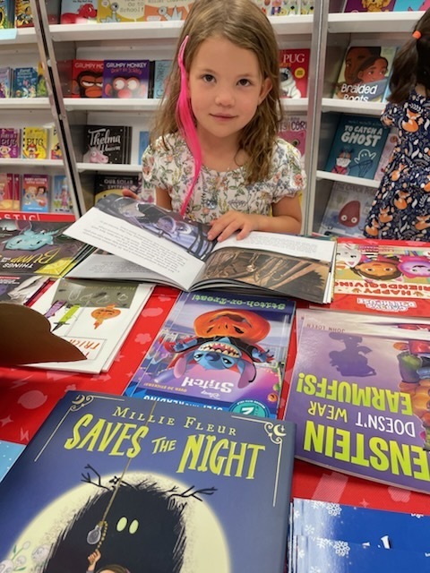 Student at holiday book table