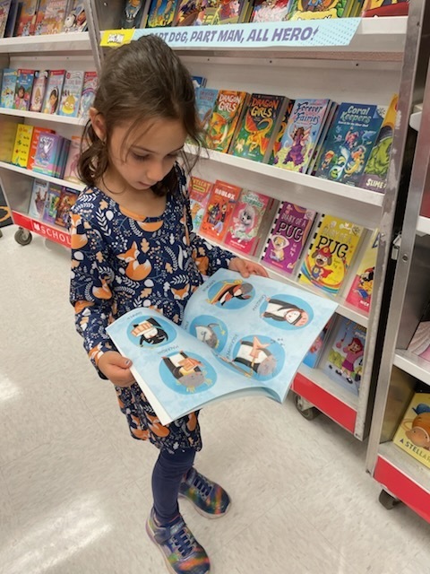Student at picture book shelf