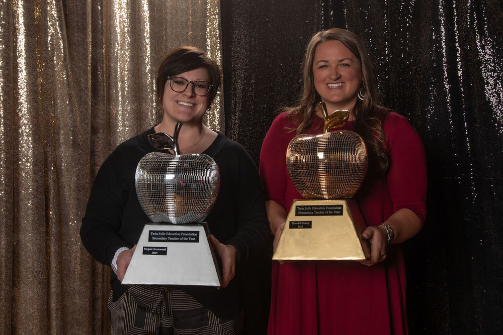 Megan Greenwood and Meredith Haney hold Teacher of the Year Trophies