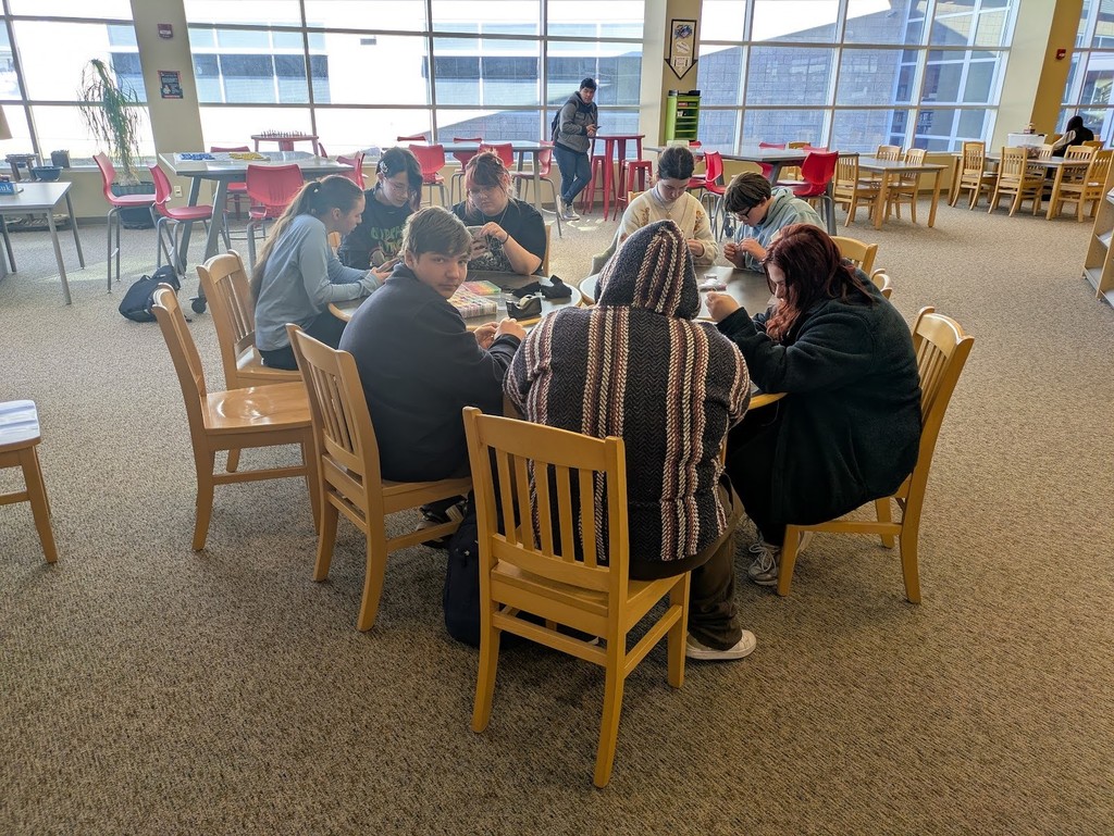CRHS students making bracelets in the library during their lunchtime.