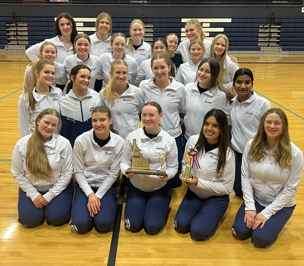 Dance team posing with trophies