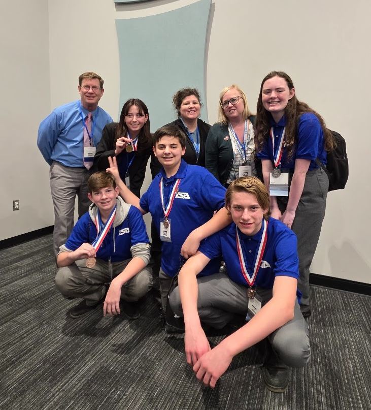 Groups of 5 students and 3 teachers smiling