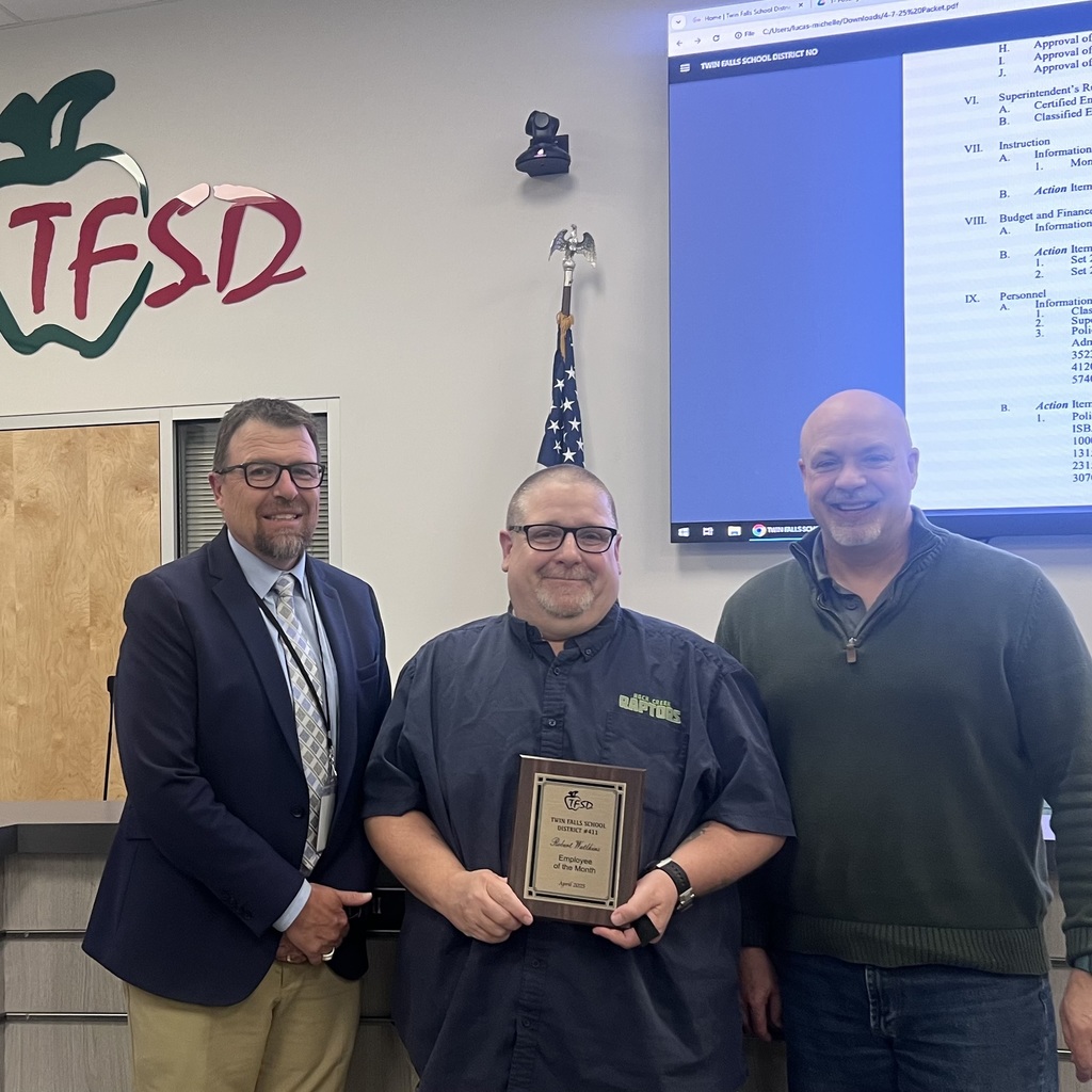 Classified employee of the month for April, Robert Watkins posing with his plaque with Dr. Dickenson and Board member Jason.