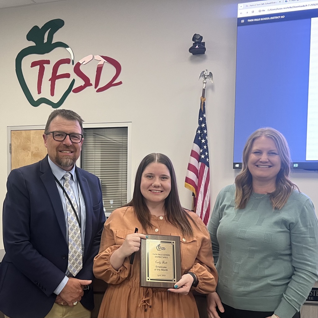 Carly Butt, Certified employee of the month for April posing with her plaque and Dr. Dickenson.