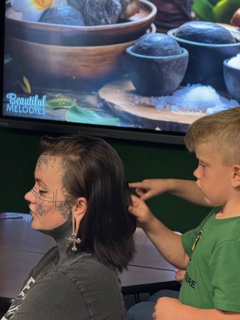 A son doing his moms hair for mothers day at spatacular.