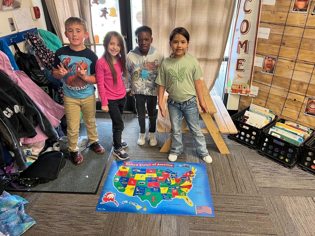 Kids at Lincoln Elementary with a map they made together for "T day".