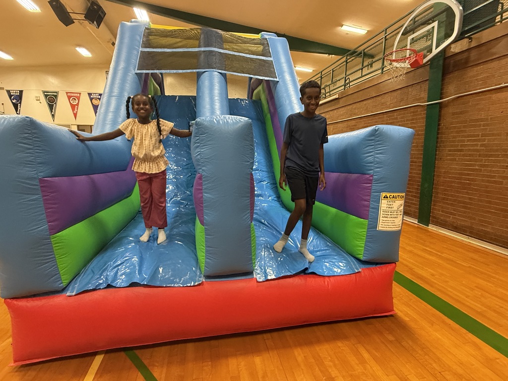 Students on an inflatable slide.