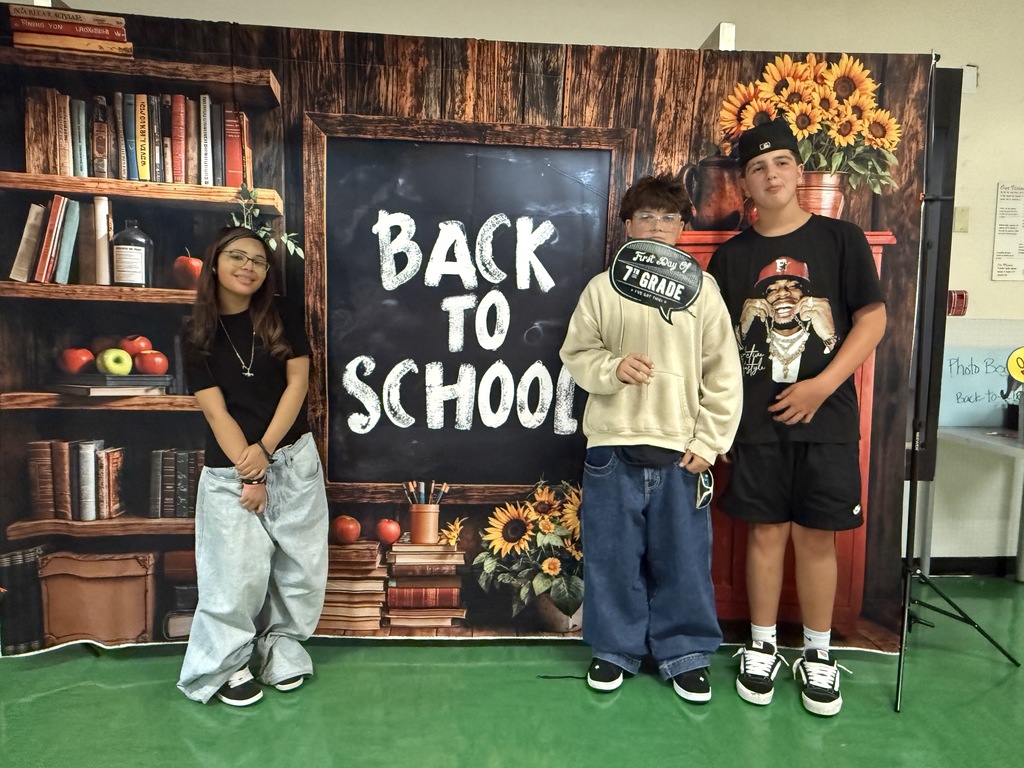 Back to school backdrop with students standing in front of it.