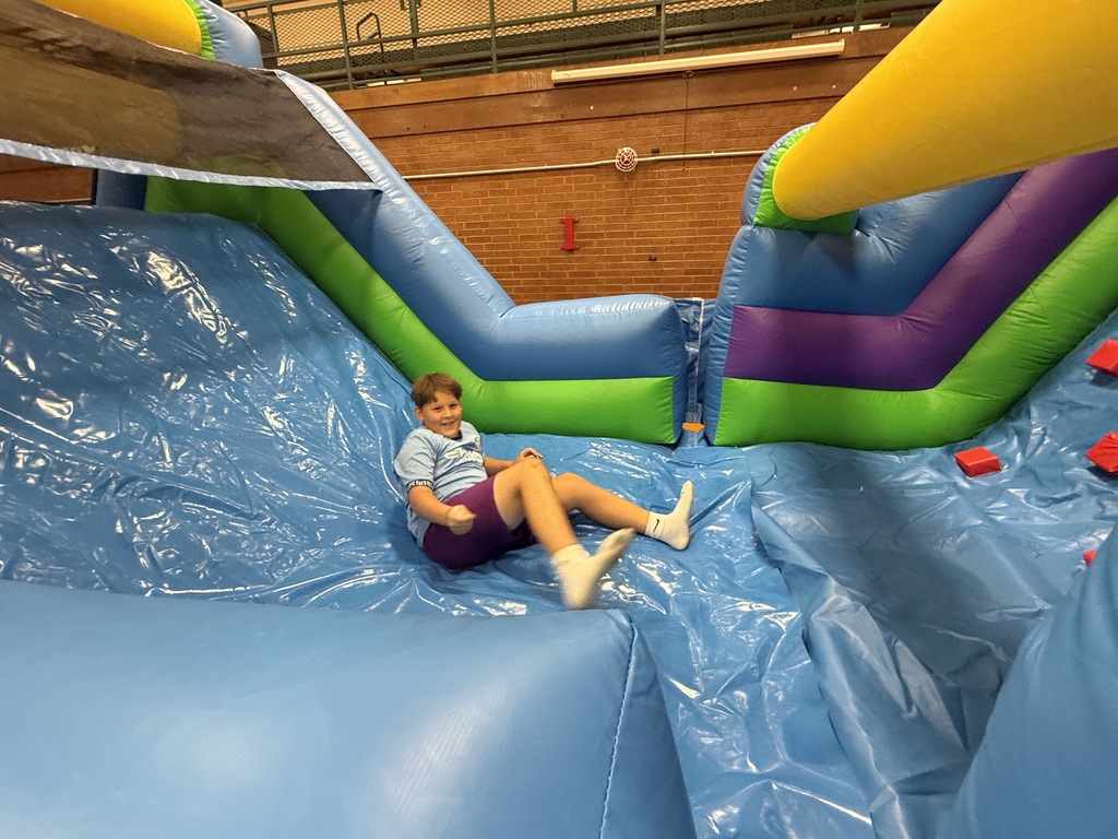 Student playing on the inflatable slide.