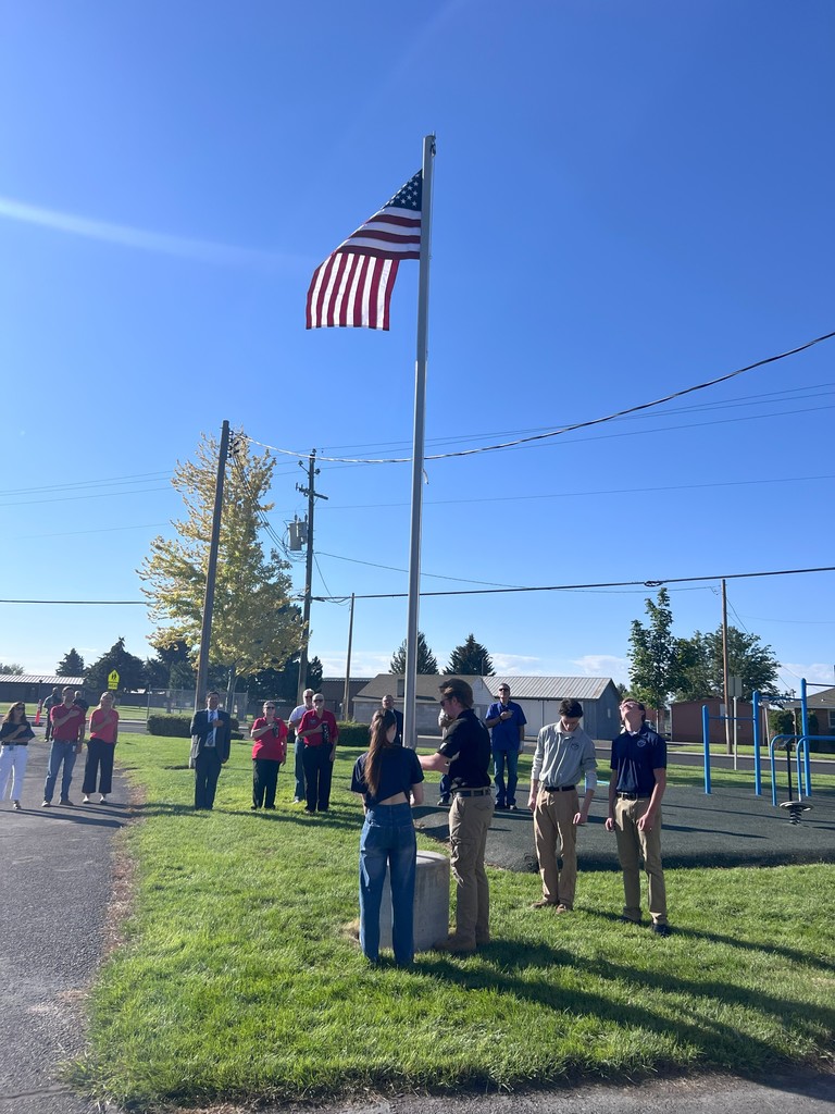 Bridge Academy Raising the flag for the new flagpole on campus