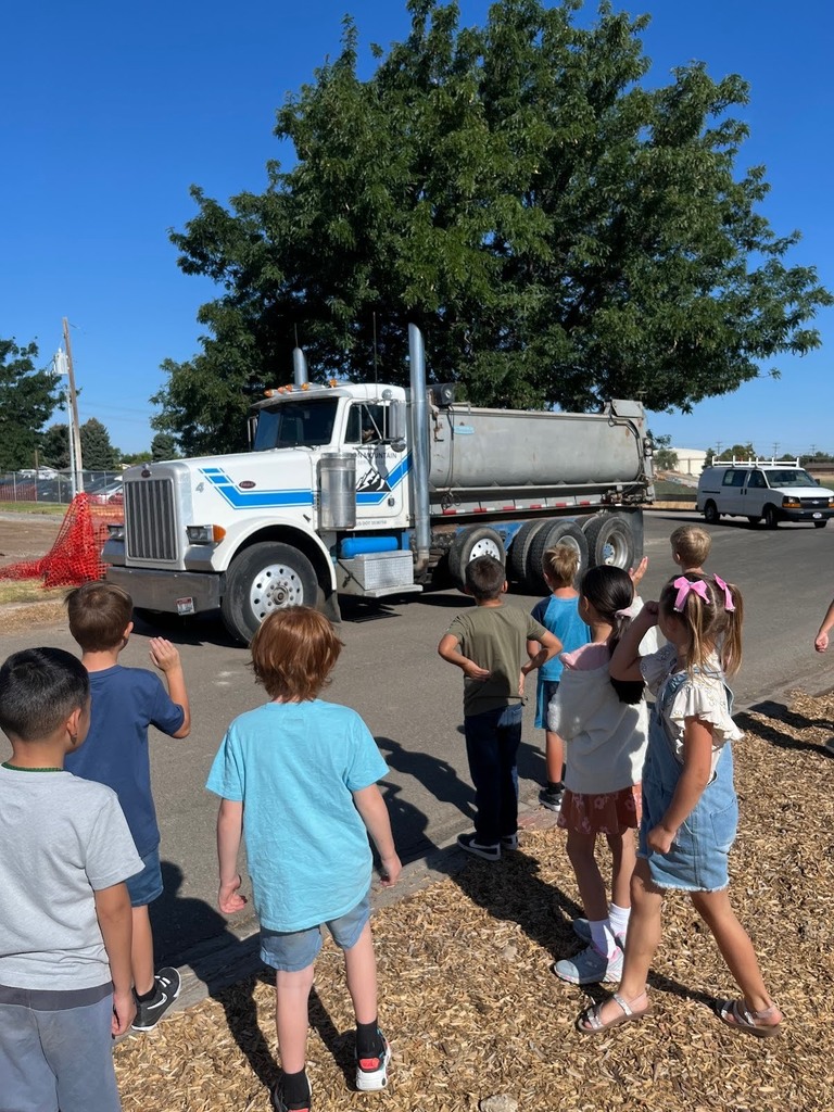 Harrison and 2nd graders watching the new aadaptive playground be built