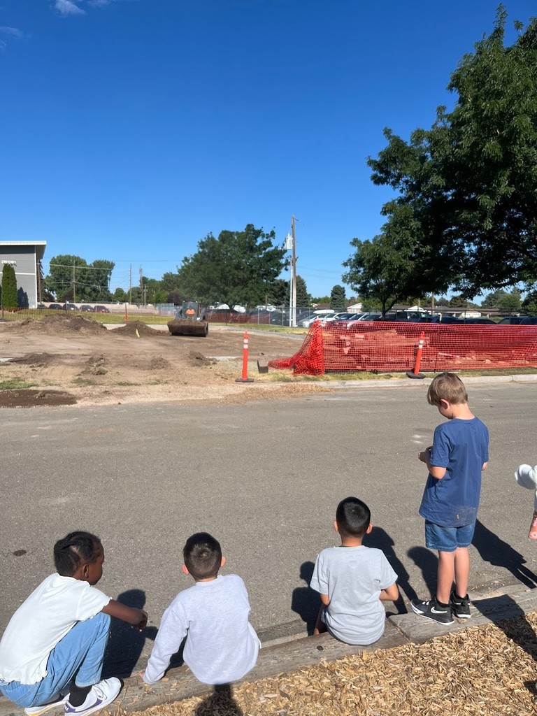 Harrison and 2nd graders watching the new aadaptive playground be built
