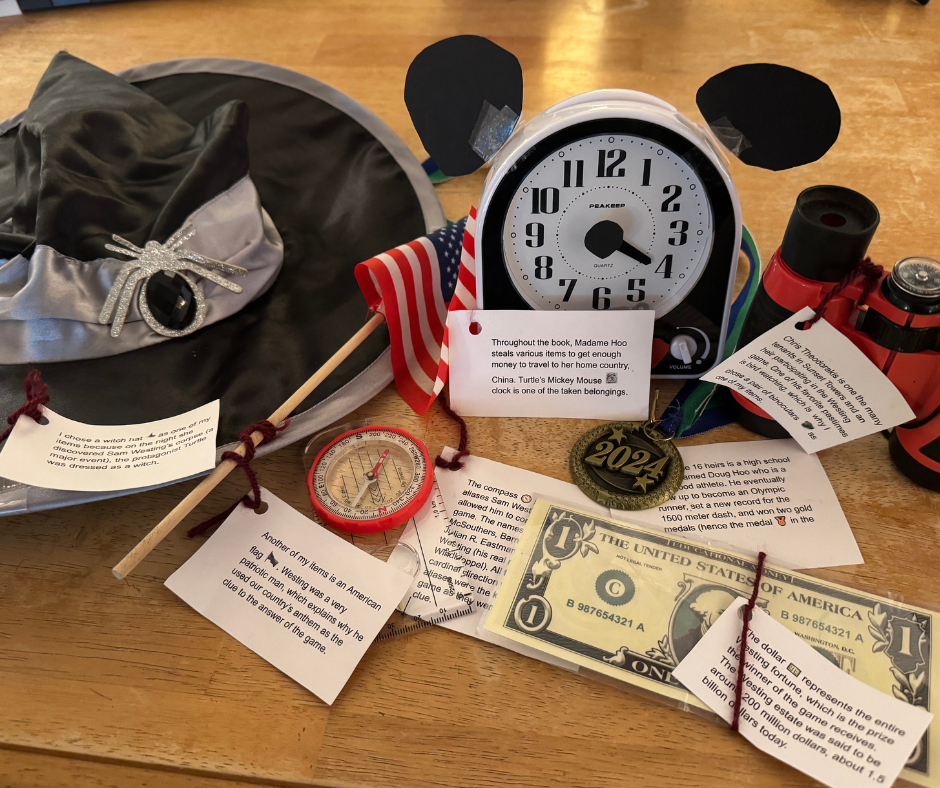 a picture of book artifacts clock, a hat, a flag, a dollar bill sitting on a tabletop