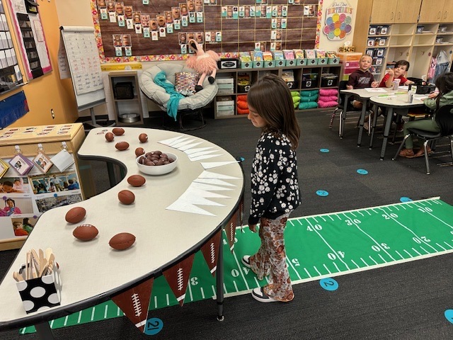 student choosing a football banner