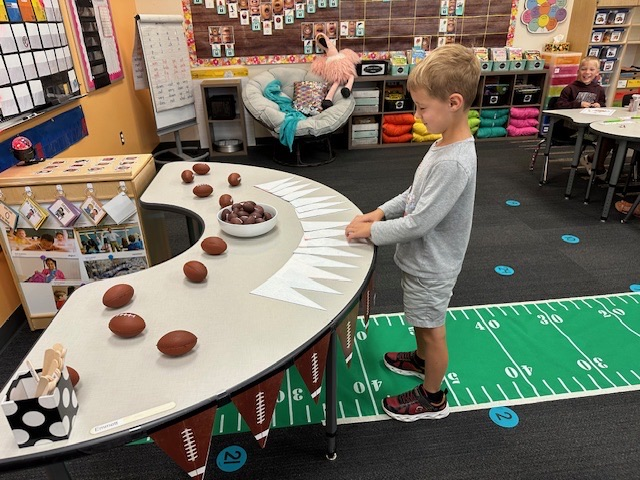 student choosing a football banner