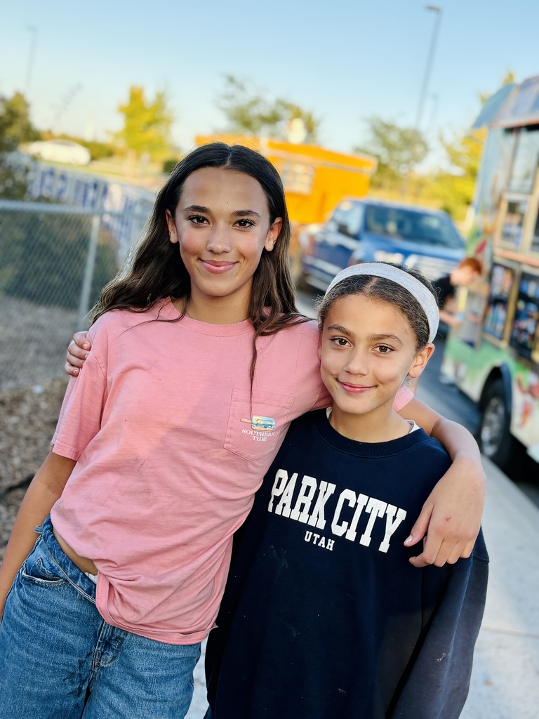 girls standing by a food truck