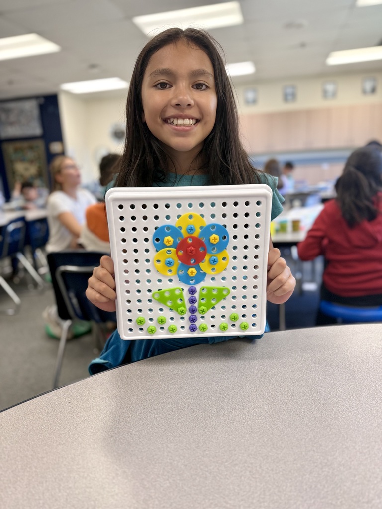 Student smiling with flower she made
