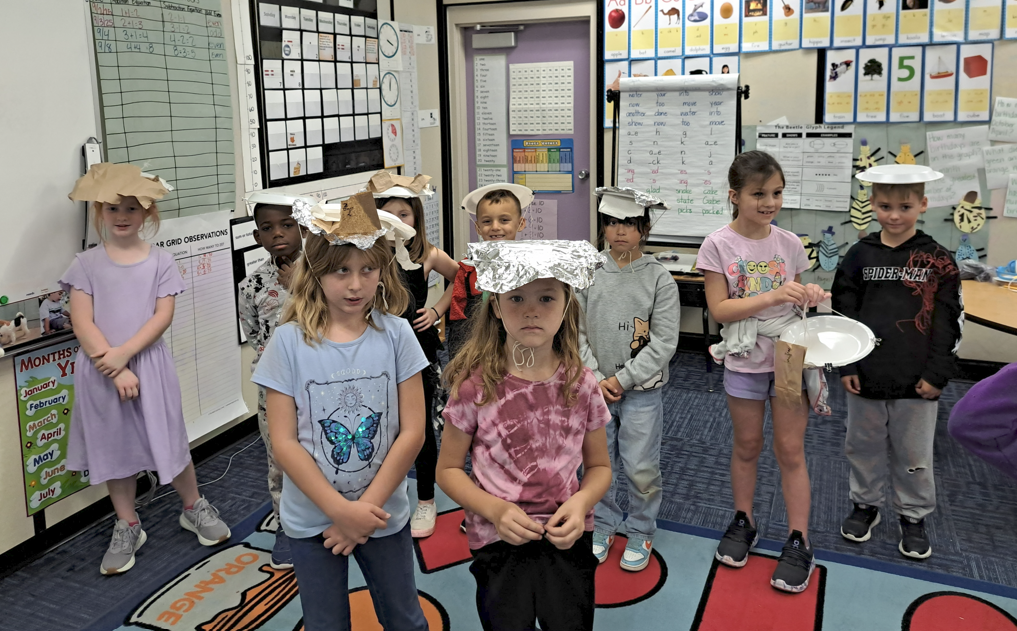 Mr.s Newlin's Wnd grade class making sun protection hats.
