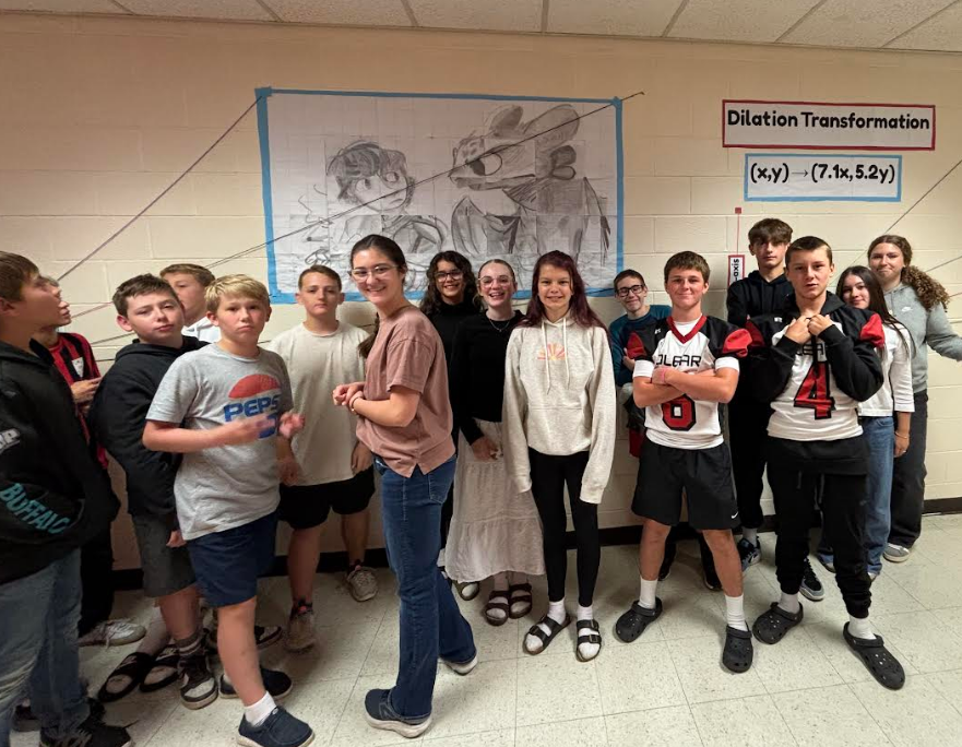 O'leary middle school students showing their work with their transformed pictures from How to Train Your Dragon using dialtaions and applying the scare rule to enlarge each shape.
