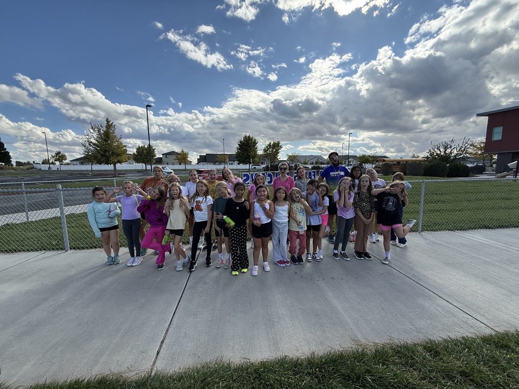 a group of girls in running clothes posing for a picture