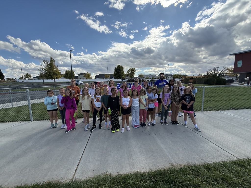 a group of girls in running clothes posing for a picture