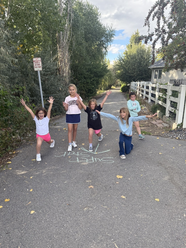 girls running on a path, posing with smiling faces