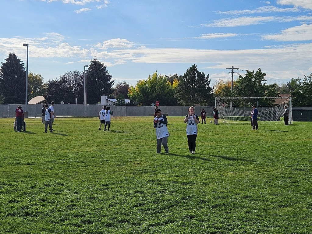 CRHS Unified Soccer . Students on the feild hitting th pitche for little soccer.