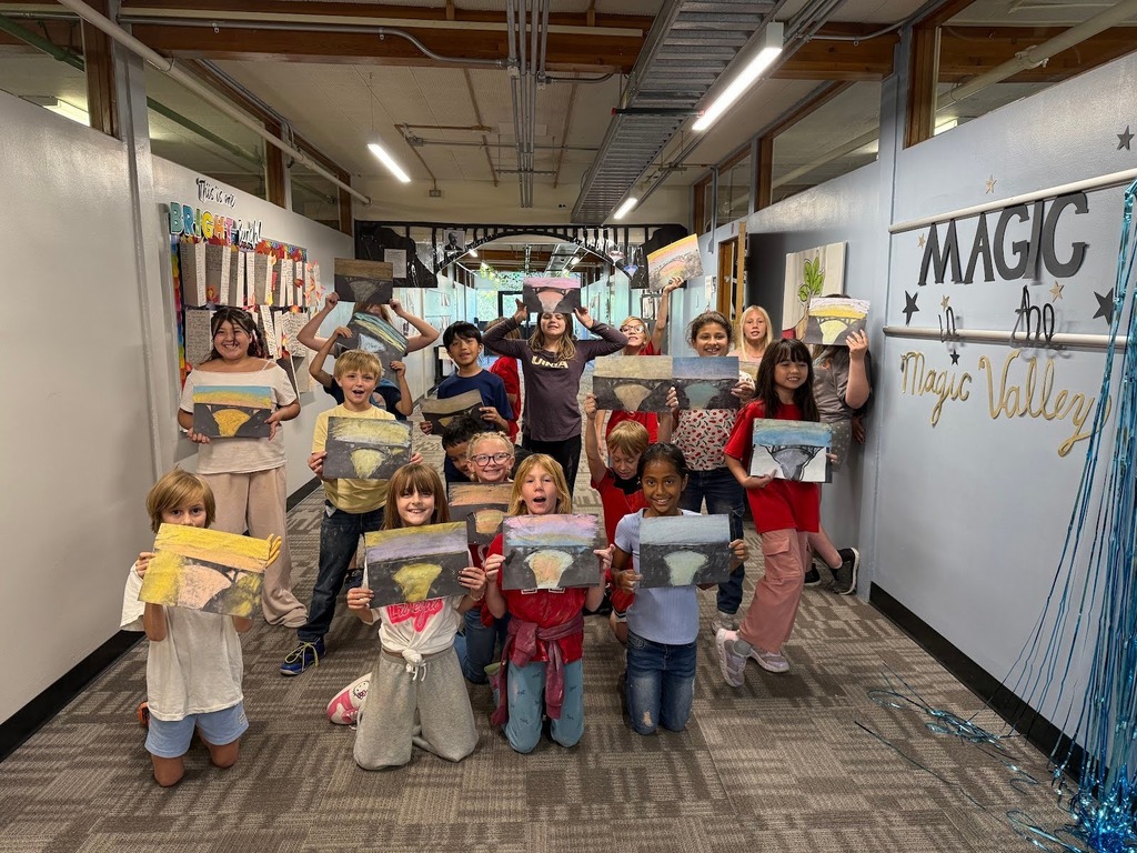 Students at Morningside Elementary holding drawings of the Perrine Bridge in their hallway that has been decorated with the Perrine Bridge.
