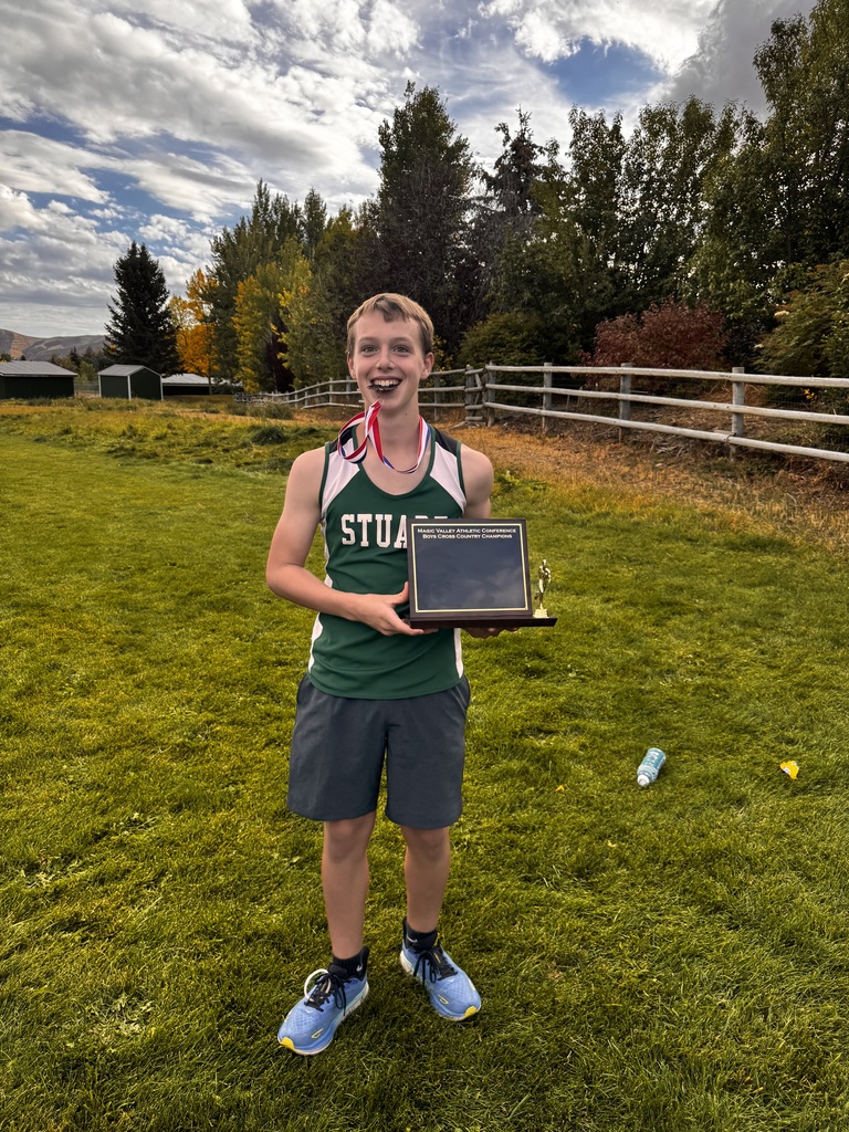 A picture of a student holding a plaque for 5th place.