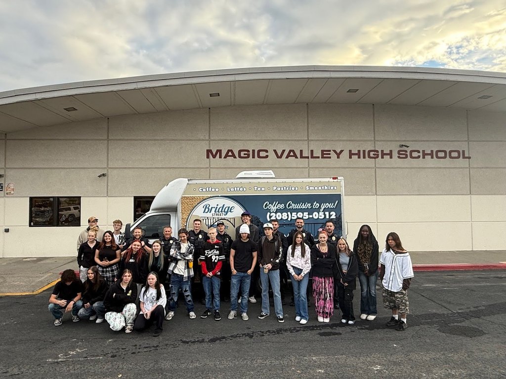 Coffee with a cop at Magic Valley High School. A picture of students and cops with the coffee van.