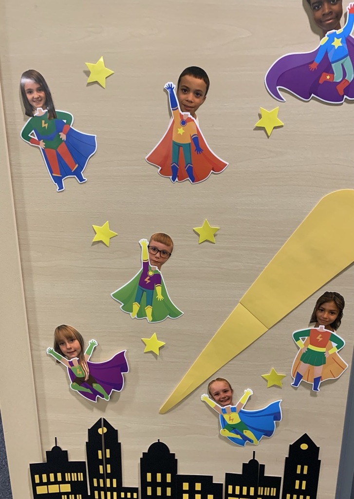 Picture from a bulletin board of third graders, dressed up as superheroes