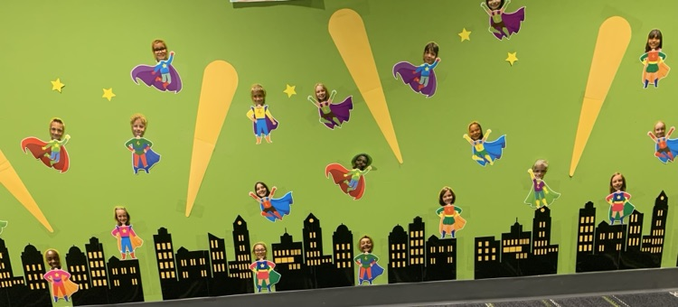 Picture from a bulletin board of third graders, dressed up as superheroes
