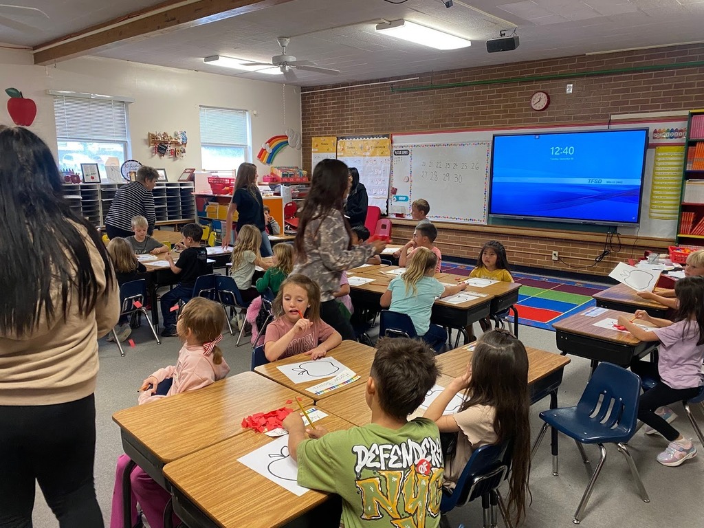 Bridge Academy students working along side Morningside 1st graders and creating apples.