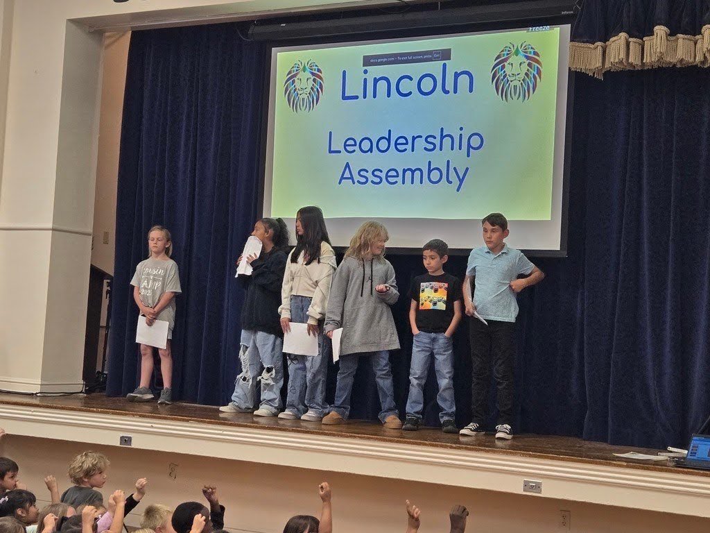 Student's at Lincoln on stage presenting awards for the Leadership Assembly