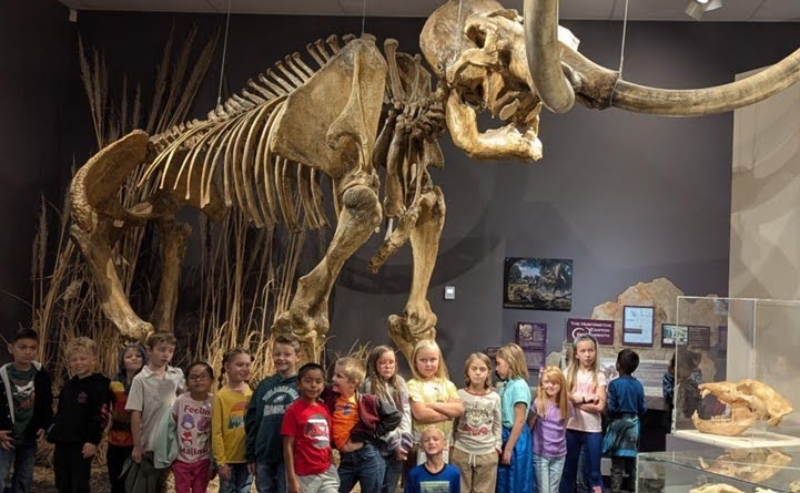 Morningside 2nd graders standing in front of a mammoth skeleton at the Herrett's Center.