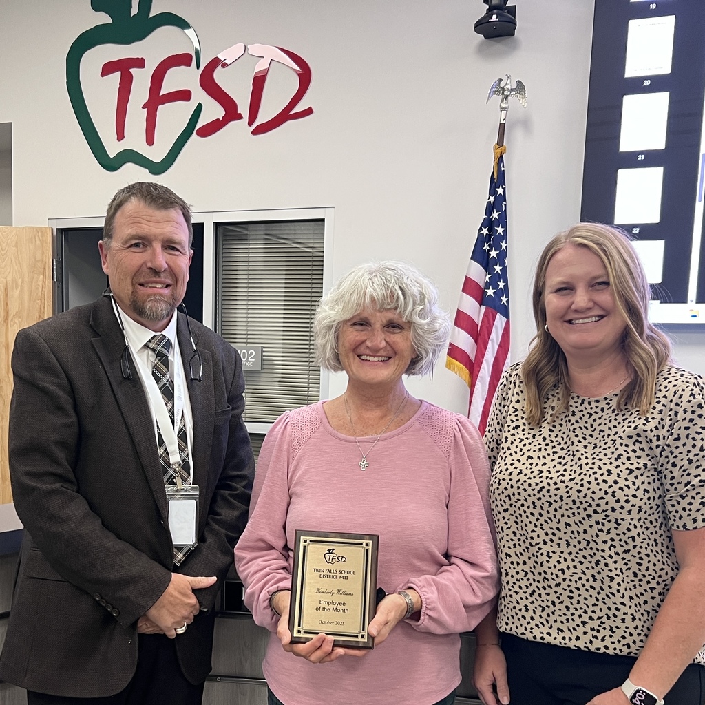 Kimberly Williams holding her Employee of the Month Plaque for October with Dr. Dickenson and Board Memeber.