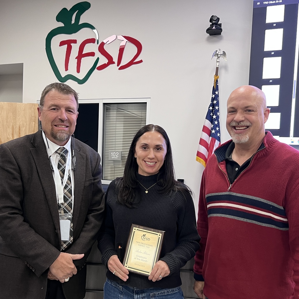 Amber with Dr.Dickenson and Board Member Jayson holding her Employee of the Month Plaque for October.