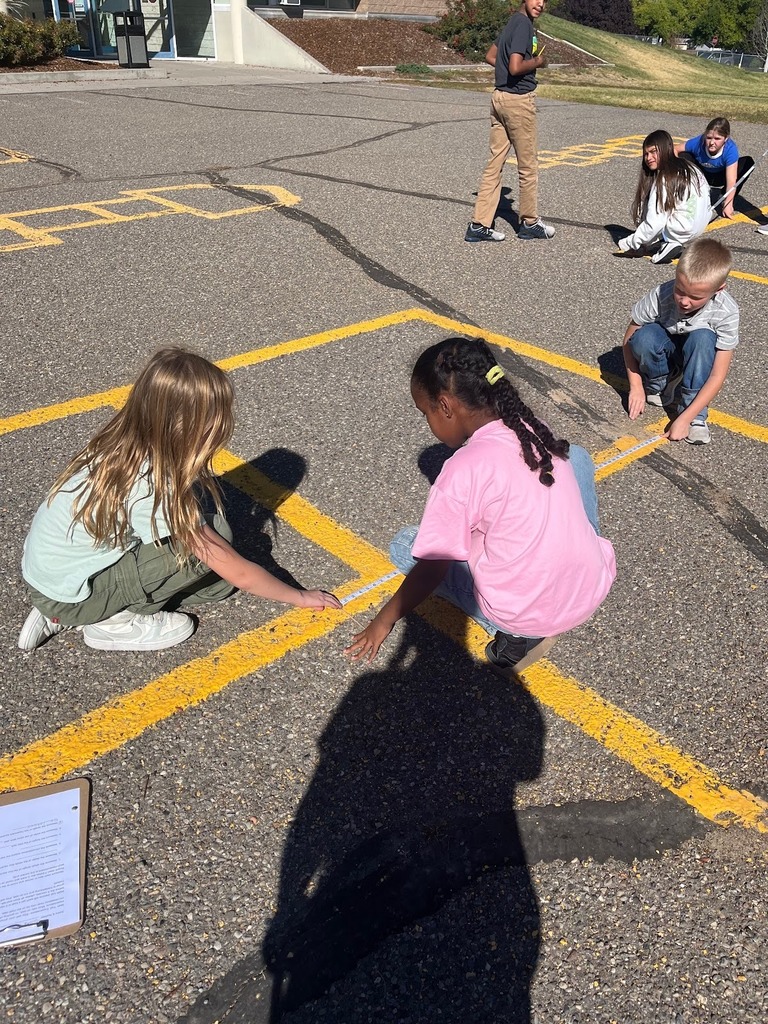 Perrine students learning about measurement with walking math trails lesson outside.