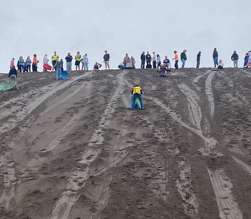 O'leary students using sleds to slide down the sand dunes at Bruneau Sand Dunes