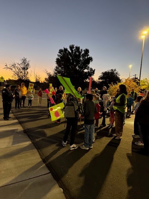 Morningside students on National Walk to School Day with saftey signs and police officers teaching them about safety.