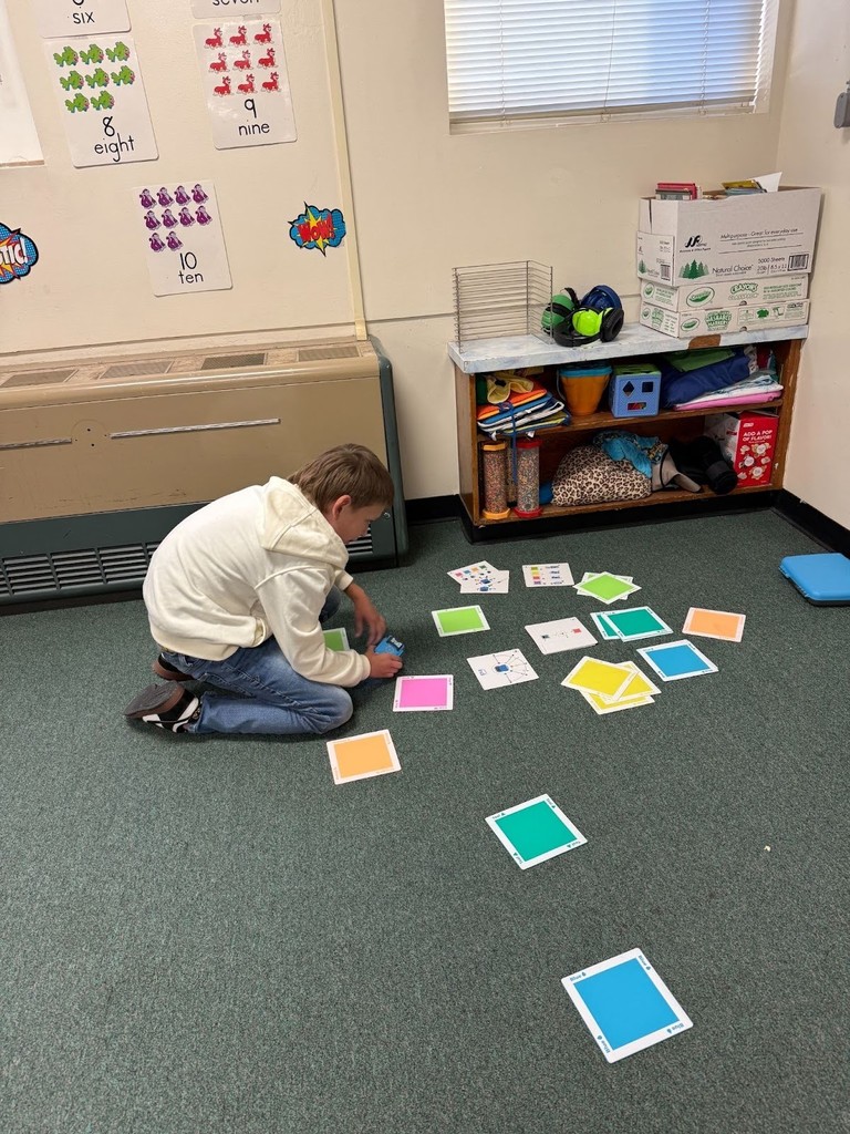 Harrison student at family stem night working on shapes and colors.
