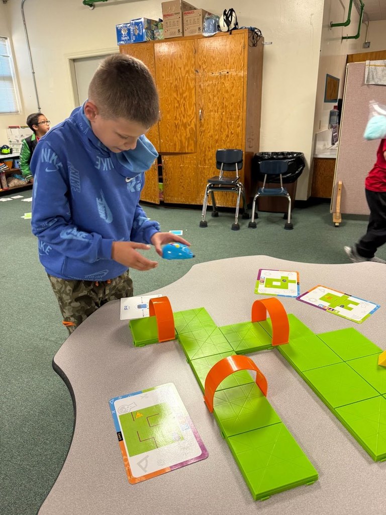 Student at Harrison Elementary working  on maze at STEM night.