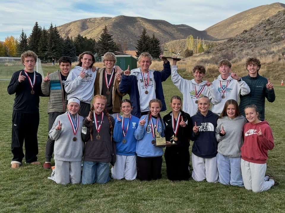 TFHS girls and boys cross country team with their medals after winning District championship.
