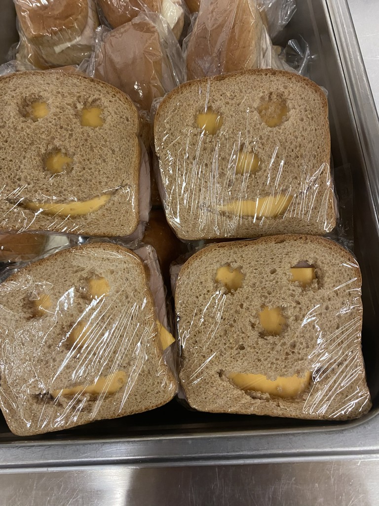 cheese sandwiches with faces cut out of the bread