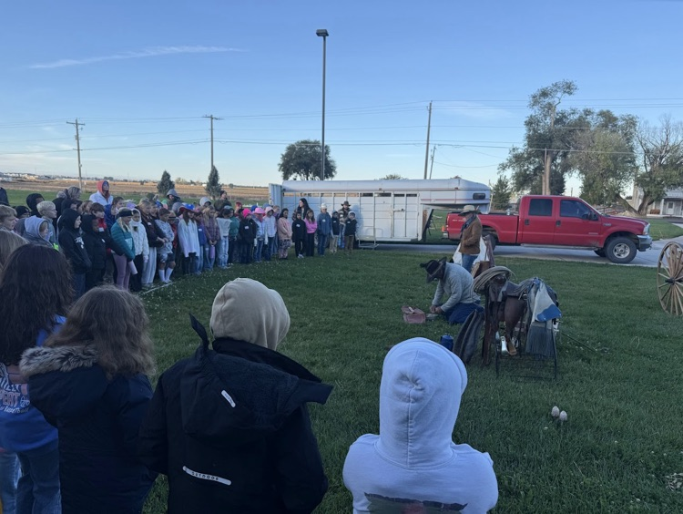 Students outside watching a demonstration