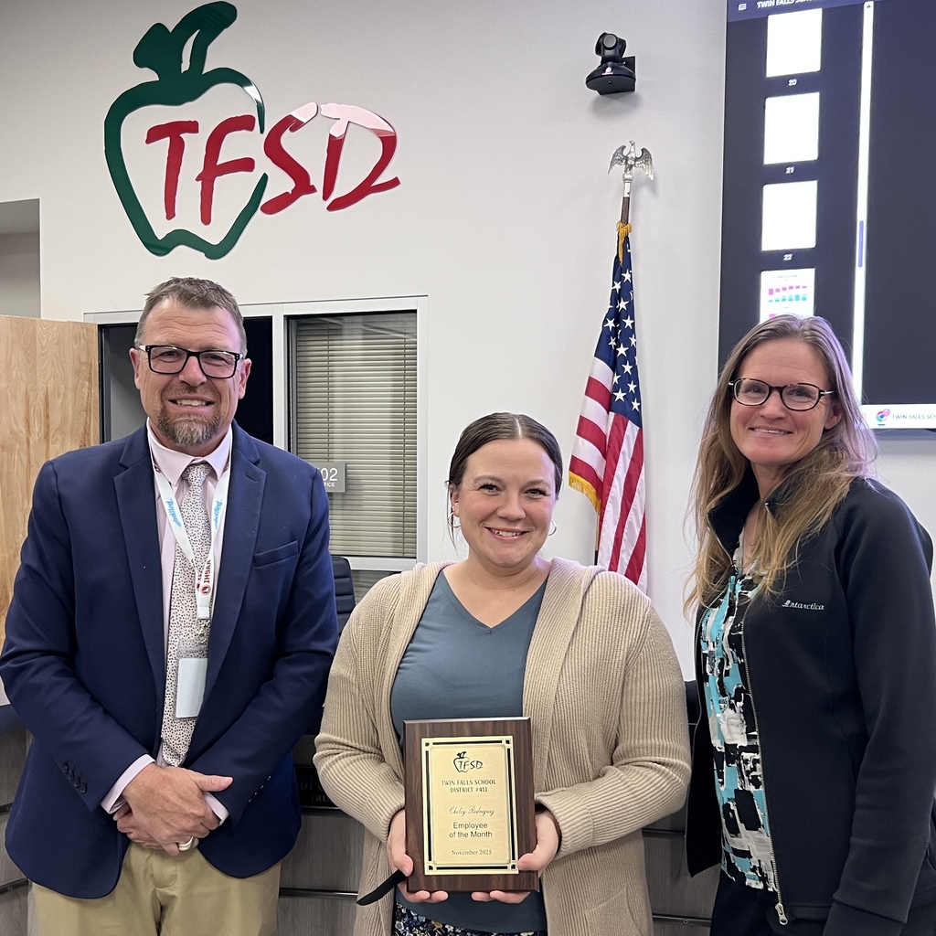 Chelcy Rodriguez receives a plaque from Dr. Dickinson and a School Board trustee.
