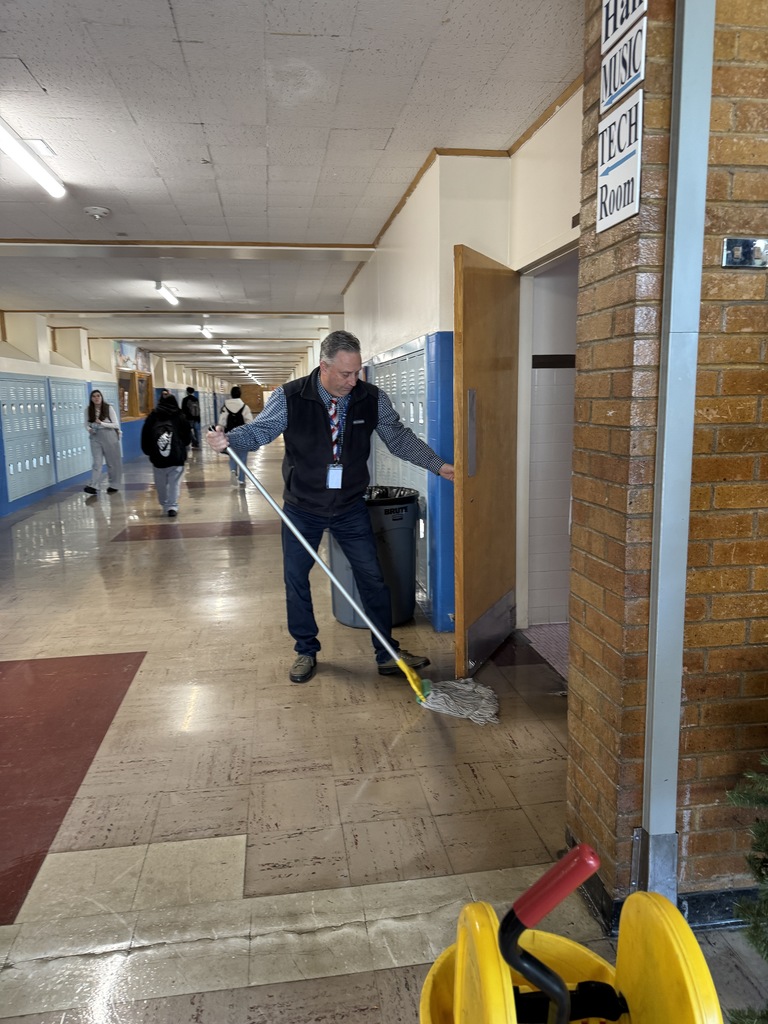 Mr. Graham mops a wet floor at TFHS